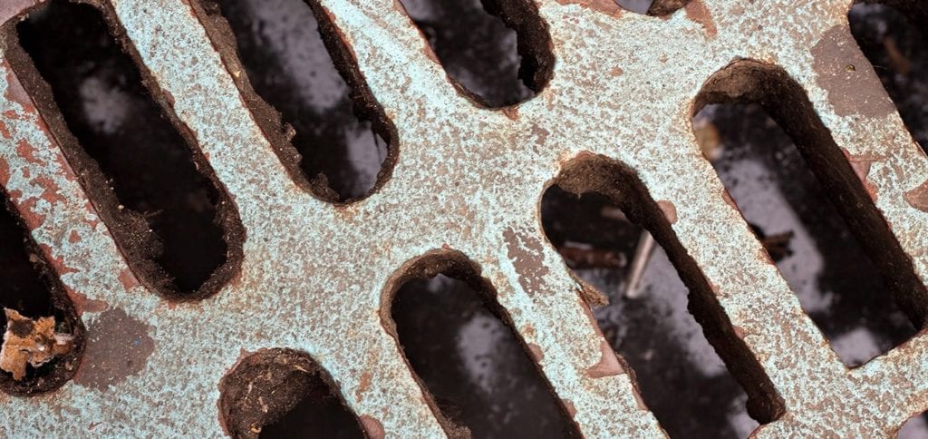 a-metal-sewer-grate-texture-that-is-worn-and-weathered_HFXdZuCro-1375x650
